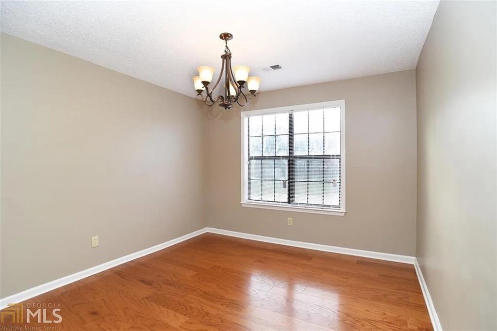 11058 Hunters Lane Hampton, GA 30228 - Photo 5 of 25 an empty room with a empty space and windows