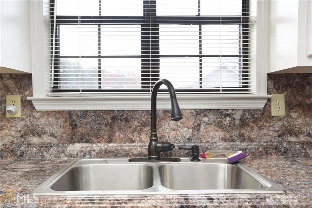 11058 Hunters Lane Hampton, GA 30228 - Photo 9 of 25 a kitchen with a sink and a window
