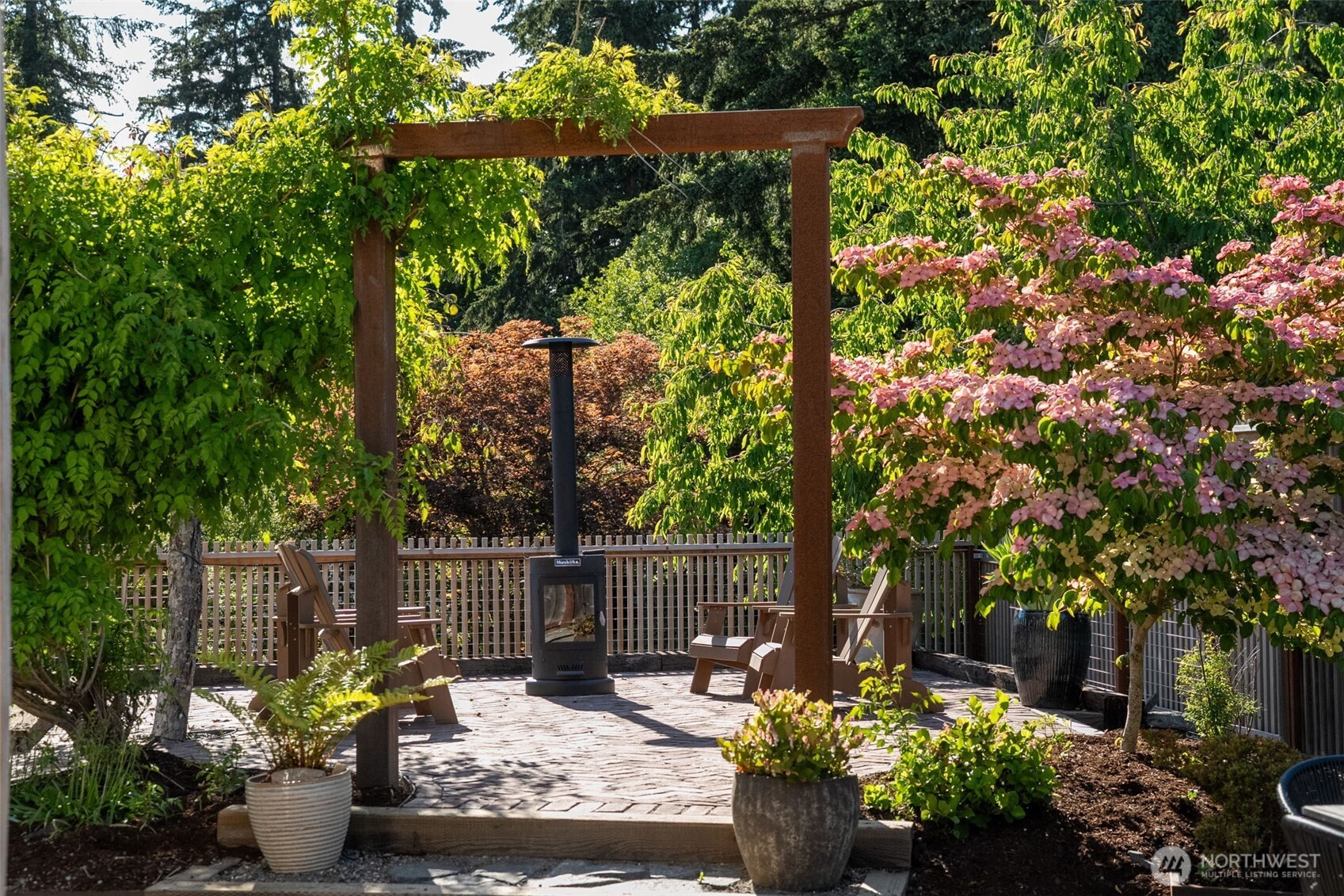 503 5th Street Steilacoom, WA 98388 - Photo 32 of 40 a wooden bench with some plants and trees