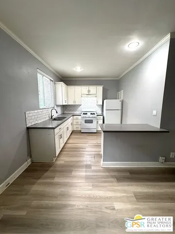 a kitchen with stainless steel appliances granite countertop a sink and a stove