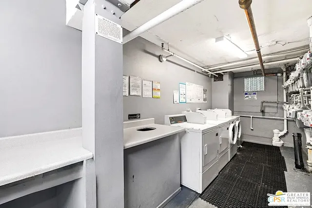 a kitchen with a sink a stove and cabinets