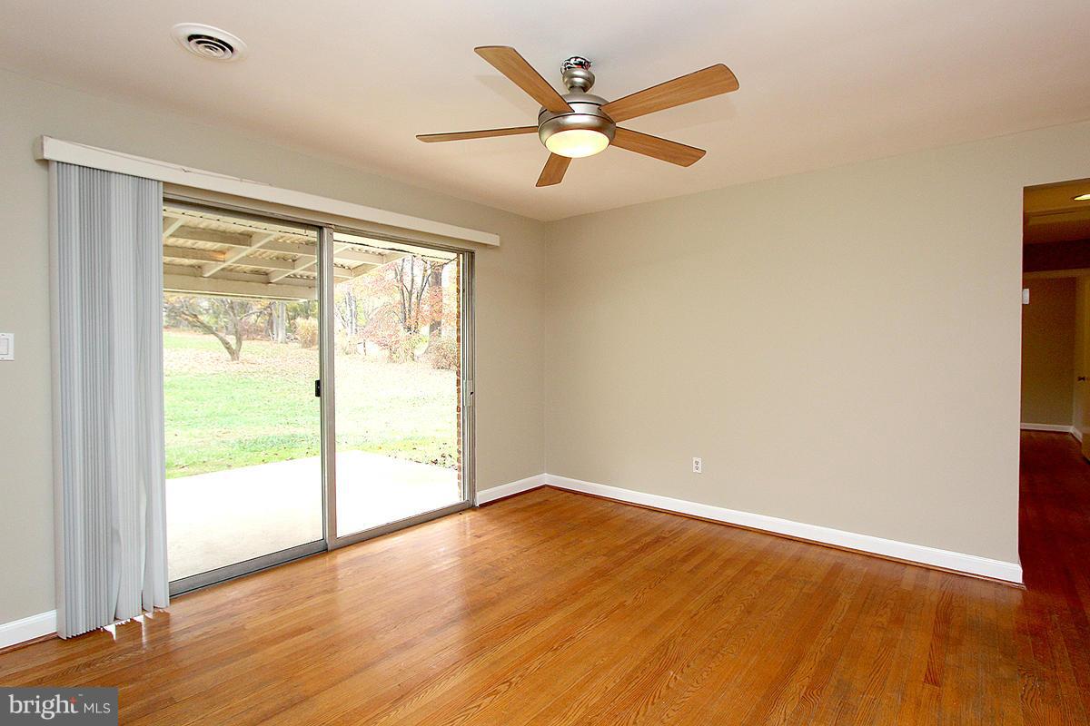17216 Donora Road Silver Spring, MD 20905 - Photo 13 of 28 a view of an empty room with wooden floor and a window