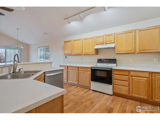 a kitchen with stainless steel appliances granite countertop a sink stove and cabinets