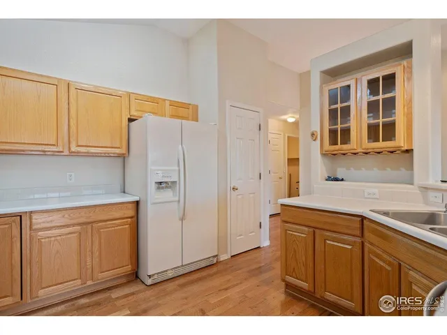 a kitchen with a refrigerator a sink and cabinets