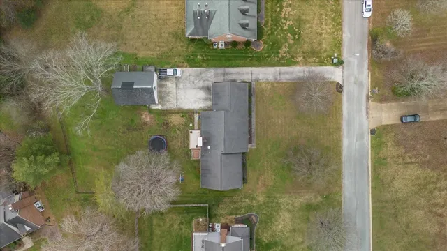 a view of a house with a yard fire pit and a table and chairs