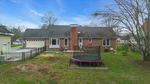 a view of a small house with backyard