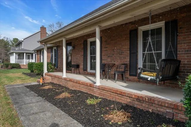 a backyard of a house with barbeque oven table and chairs