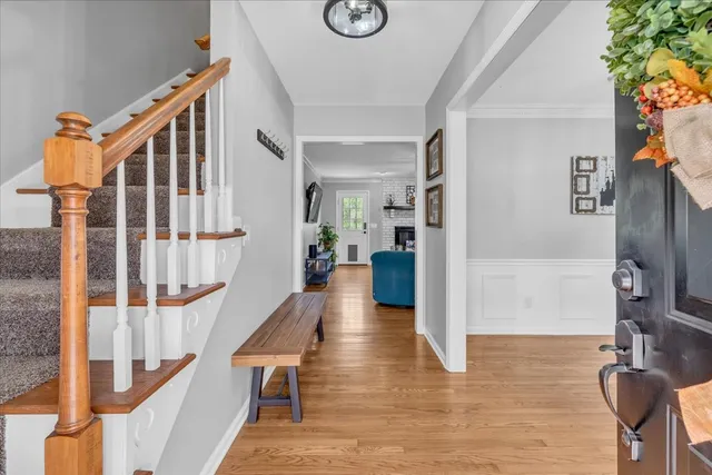 a view of an entryway with wooden floor and a front door