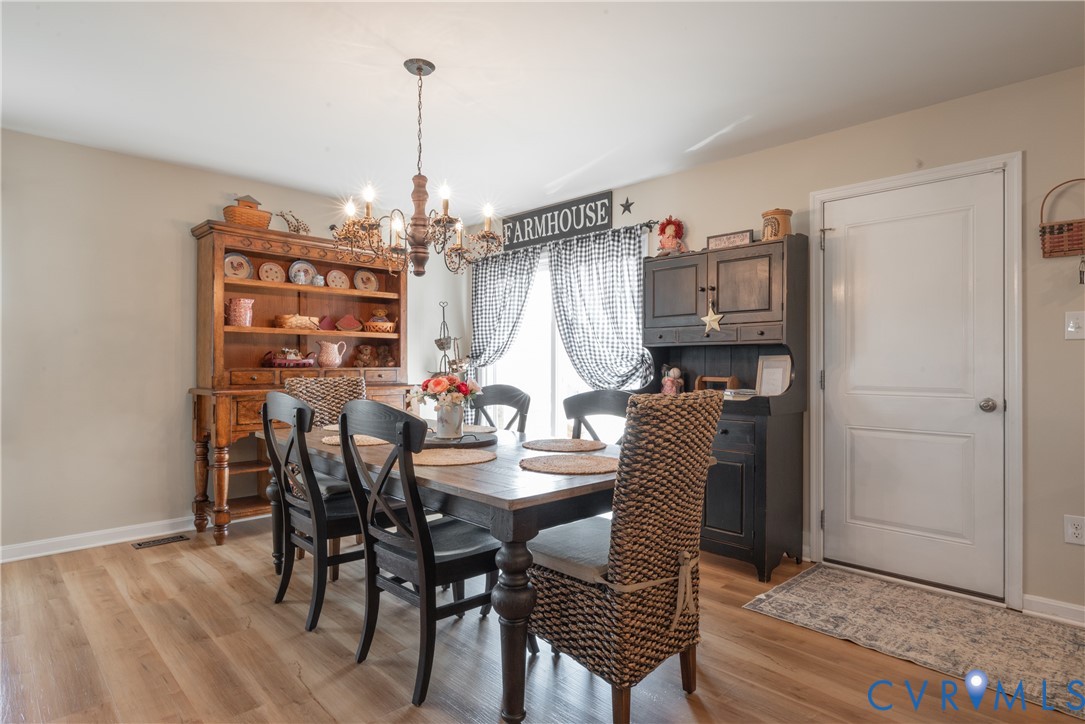17854 Meriwether Lewis Street Ruther Glen, VA 22546 - Photo 11 of 39 Dining area featuring wood-finish flooring, a deco