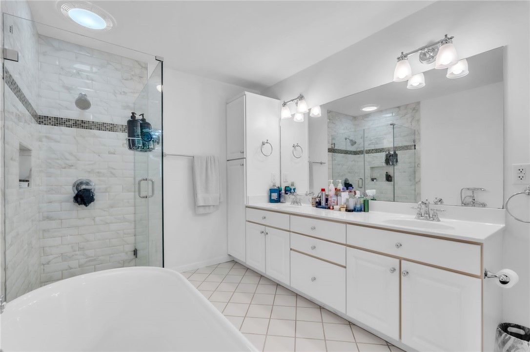 400 Arcadia Drive Anderson, SC 29621 - Photo 17 of 43 This spacious bathroom offers dual vanities, a luxurious soaking tub, and a glass-enclosed shower.