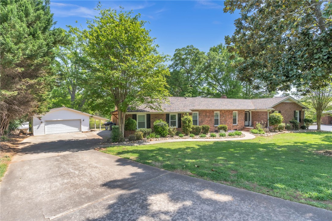 400 Arcadia Drive Anderson, SC 29621 - Photo 2 of 43 This classic brick residence features an expansive driveway and a well-manicured lawn.