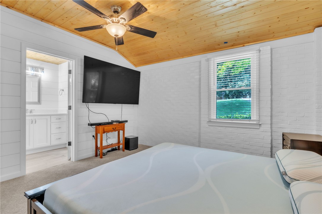 400 Arcadia Drive Anderson, SC 29621 - Photo 22 of 43 Bright and airy bedroom with a rustic wood ceiling, offering a comfortable retreat.