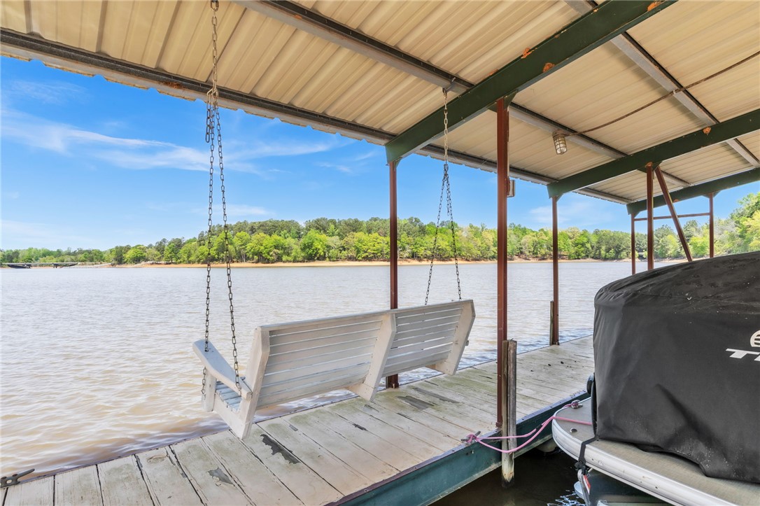 400 Arcadia Drive Anderson, SC 29621 - Photo 32 of 43 This serene waterfront setting includes a private dock with an inviting swing, offering tranquil water views.