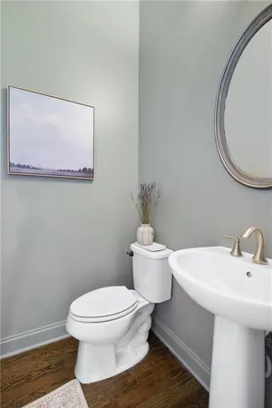 a white toilet sitting next to a bathroom sink
