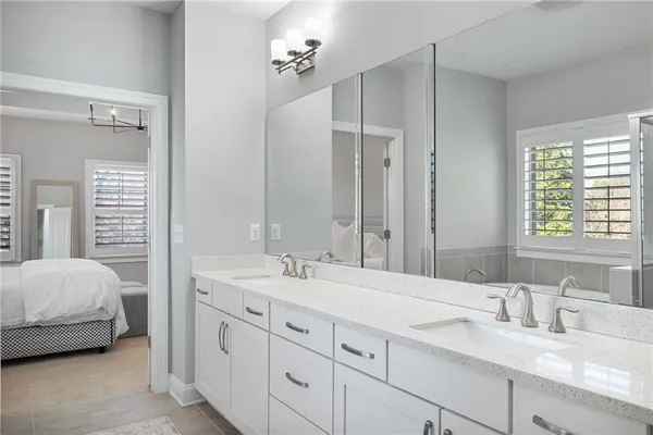a en suite bathroom with double sink a mirror and a shower