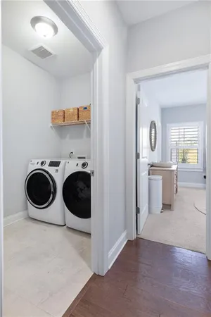 a view of a kitchen with a sink and a washer dryer