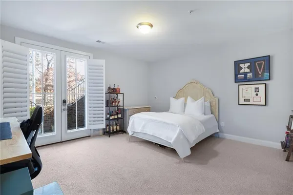 a bedroom with a bed a couch and a window
