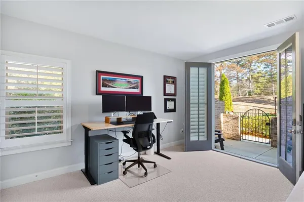 a view of a workspace with furniture and a window