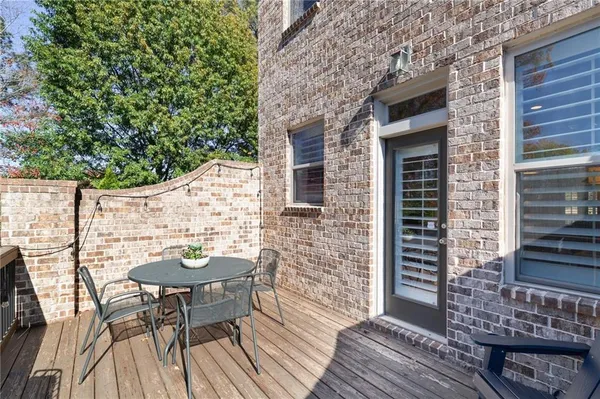 a view of a patio with table and chairs and wooden floor