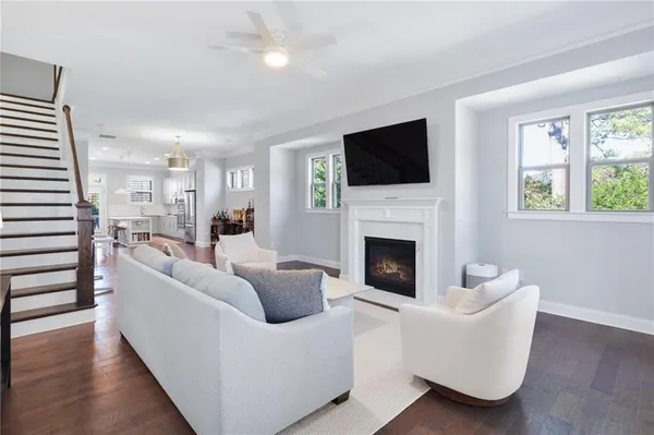 a living room with furniture a fireplace and a flat screen tv