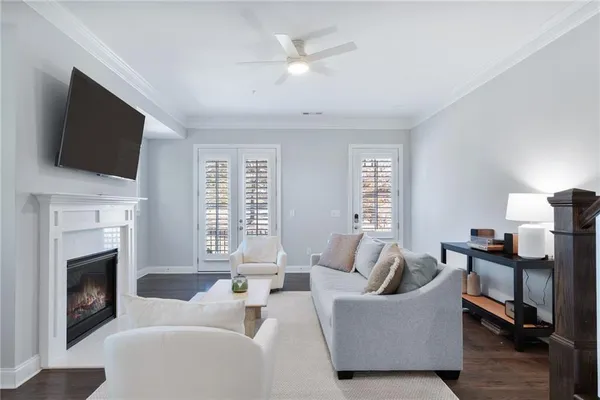 a living room with furniture a fireplace and a flat screen tv