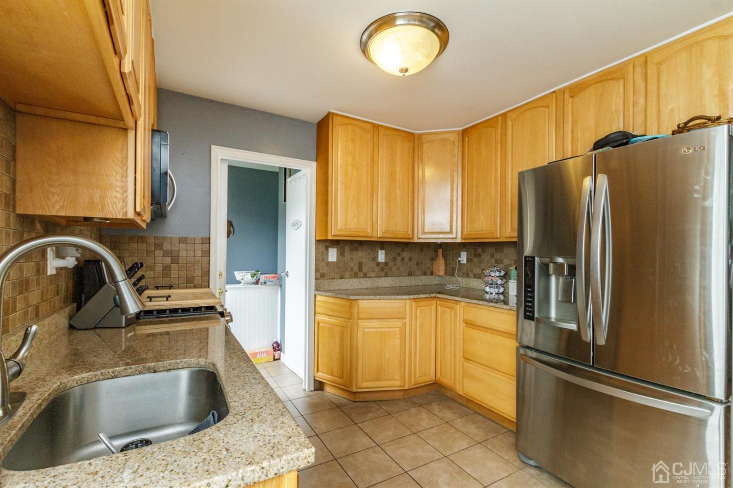 13 Argonne Avenue Hamilton, NJ 08620 - Photo 11 of 24 a kitchen with a refrigerator sink and cabinets