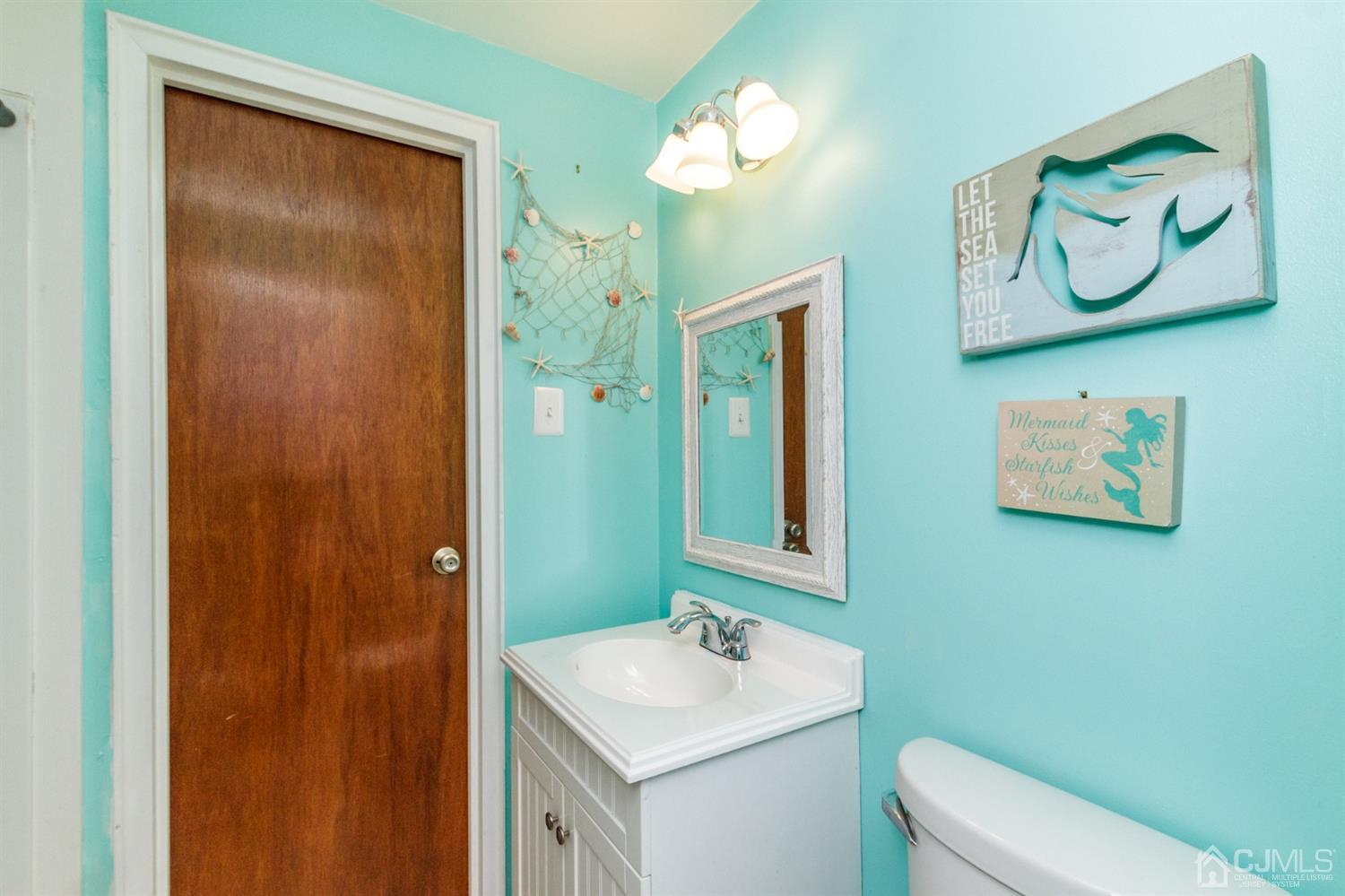 13 Argonne Avenue Hamilton, NJ 08620 - Photo 17 of 24 a bathroom with a toilet sink and mirror