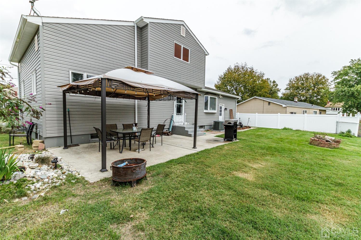 13 Argonne Avenue Hamilton, NJ 08620 - Photo 21 of 24 a view of a patio with table and chairs under an umbrella