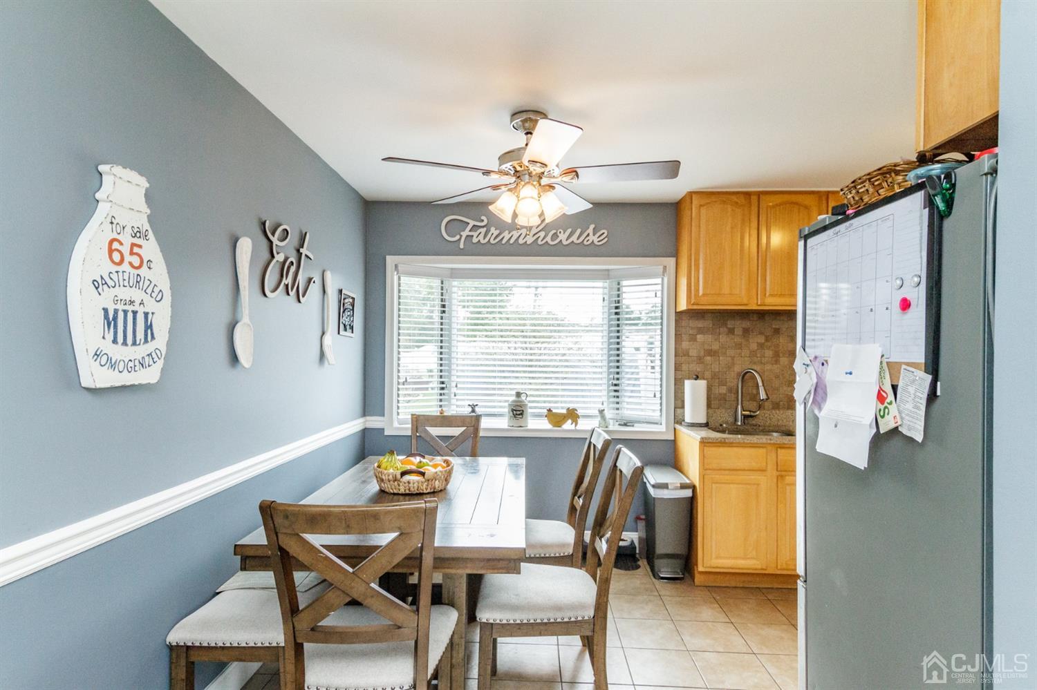 13 Argonne Avenue Hamilton, NJ 08620 - Photo 6 of 24 a view of a dining room with furniture a chandelier and a large window
