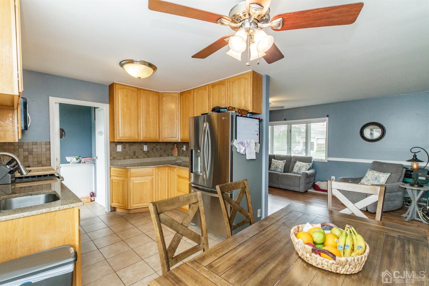 13 Argonne Avenue Hamilton, NJ 08620 - Photo 9 of 24 a kitchen with dining table and stainless steel appliances