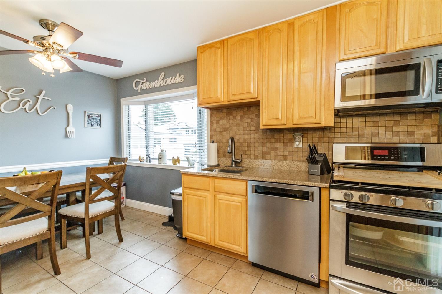 13 Argonne Avenue Hamilton, NJ 08620 - Photo 10 of 24 a kitchen with stainless steel appliances granite countertop a stove top oven a sink dishwasher and a microwave oven on the blue kitchen countertops