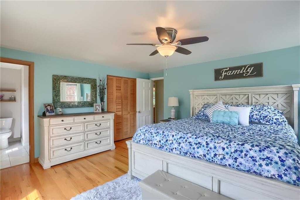 8381 Post Road Allison Park, PA 15101 - Photo 14 of 25 The master suite boasts vivid windows, hardwood flooring, and a large closet.