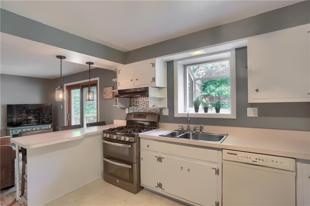 8381 Post Road Allison Park, PA 15101 - Photo 7 of 25 An island, with modern pendant lighting, provides a casual dining space. A stainless steel five burner stove features double ovens and a custom backsplash.