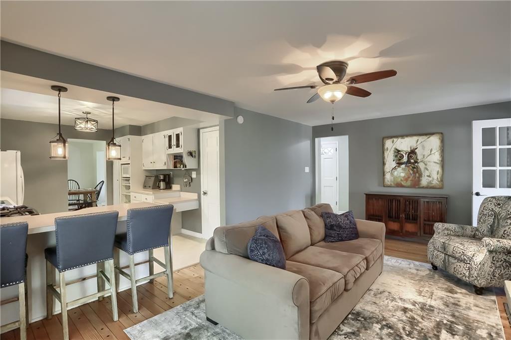 8381 Post Road Allison Park, PA 15101 - Photo 10 of 25 Other highlights include a cozy fireplace, stylish paint tone and access to the rear deck and a four seasons room.