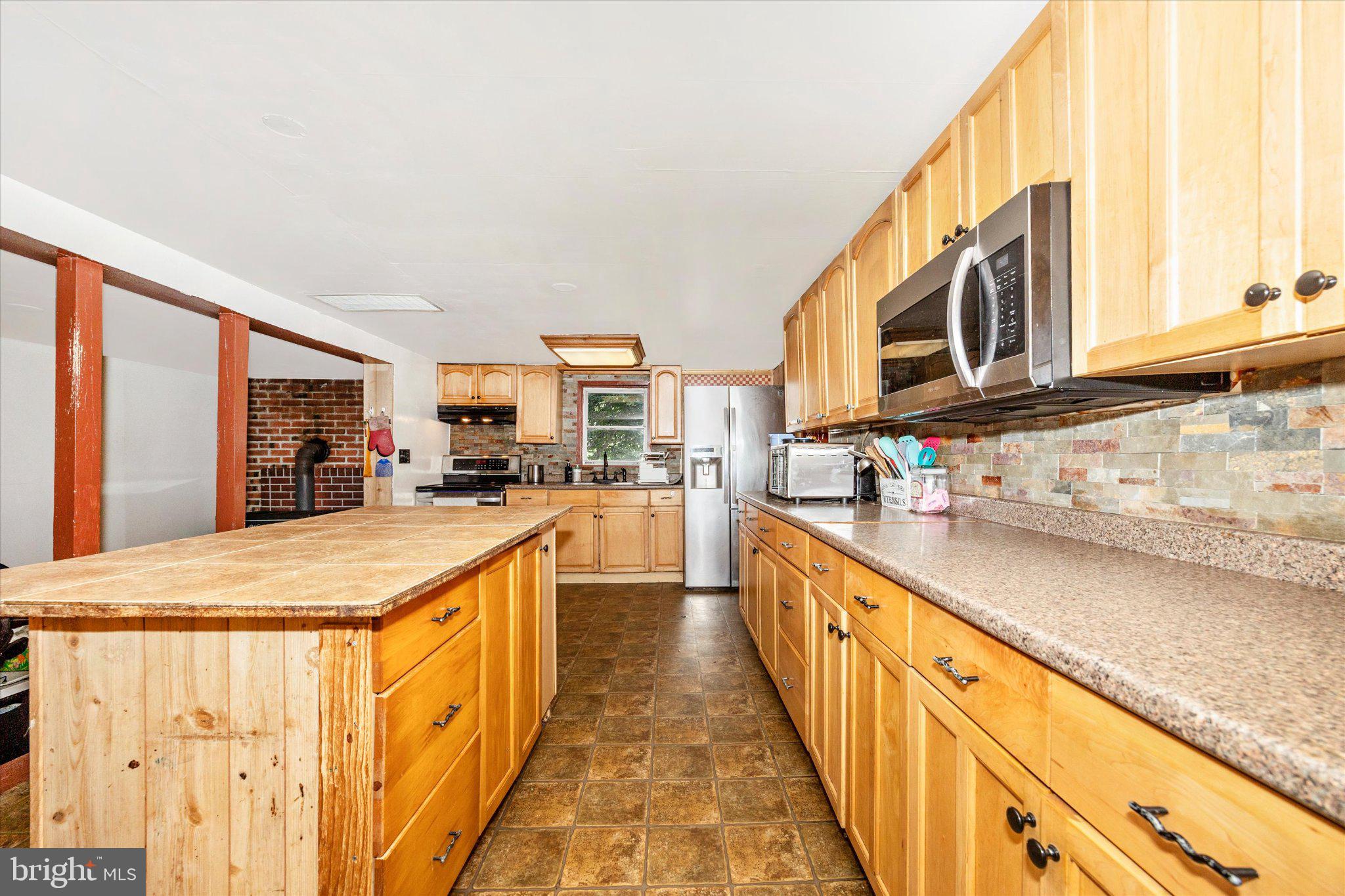14721 Albert Staub Road Thurmont, MD 21788 - Photo 7 of 46 a kitchen with stainless steel appliances granite countertop a sink and cabinets