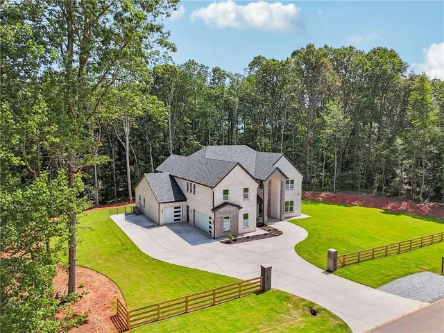an aerial view of a house with swimming pool and porch