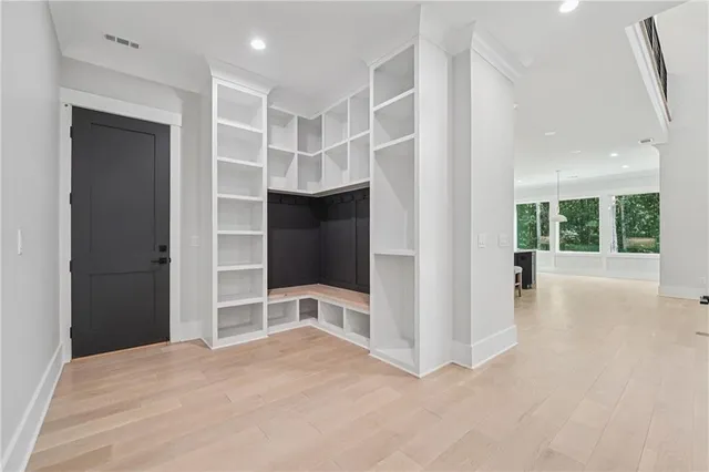 a view of a livingroom with a fireplace a chandelier and stairs