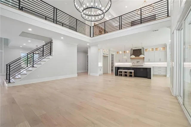 a kitchen with stainless steel appliances a sink a stove and a wooden floors