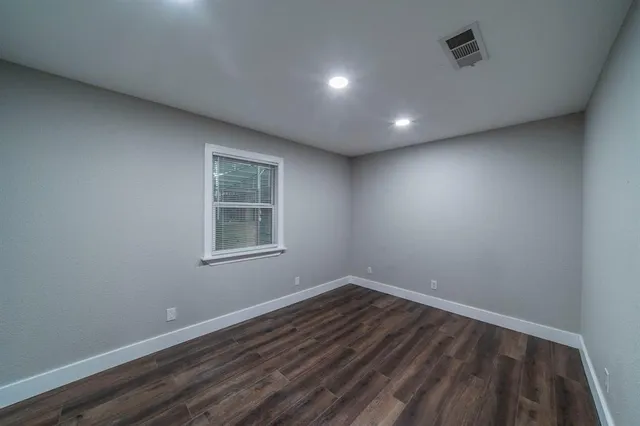 a view of a room with wooden floor and windows