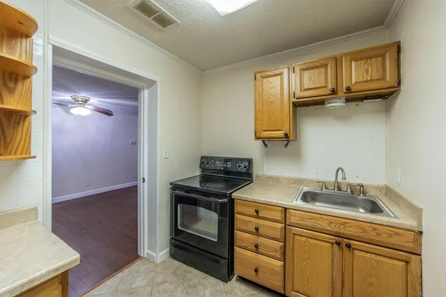 a kitchen with cabinets stainless steel appliances and a sink