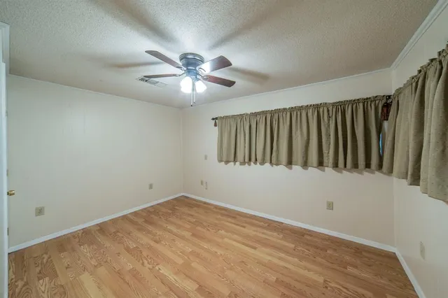 a view of empty room with ceiling fan