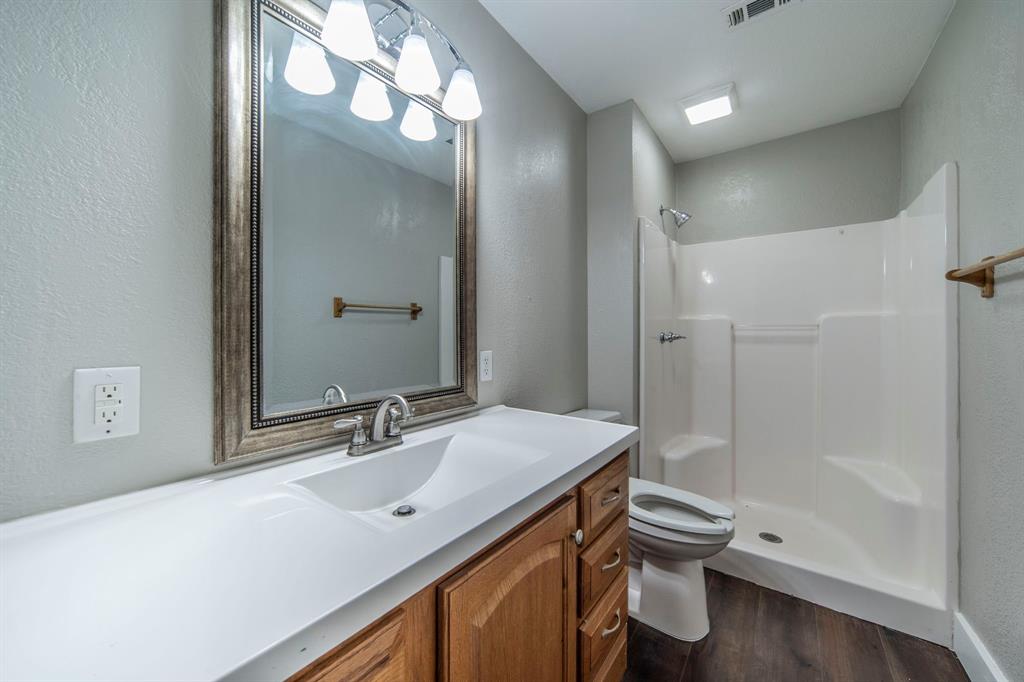 127 County Road 3051 Decatur, TX 76234 - Photo 22 of 35 a bathroom with a sink a toilet and shower