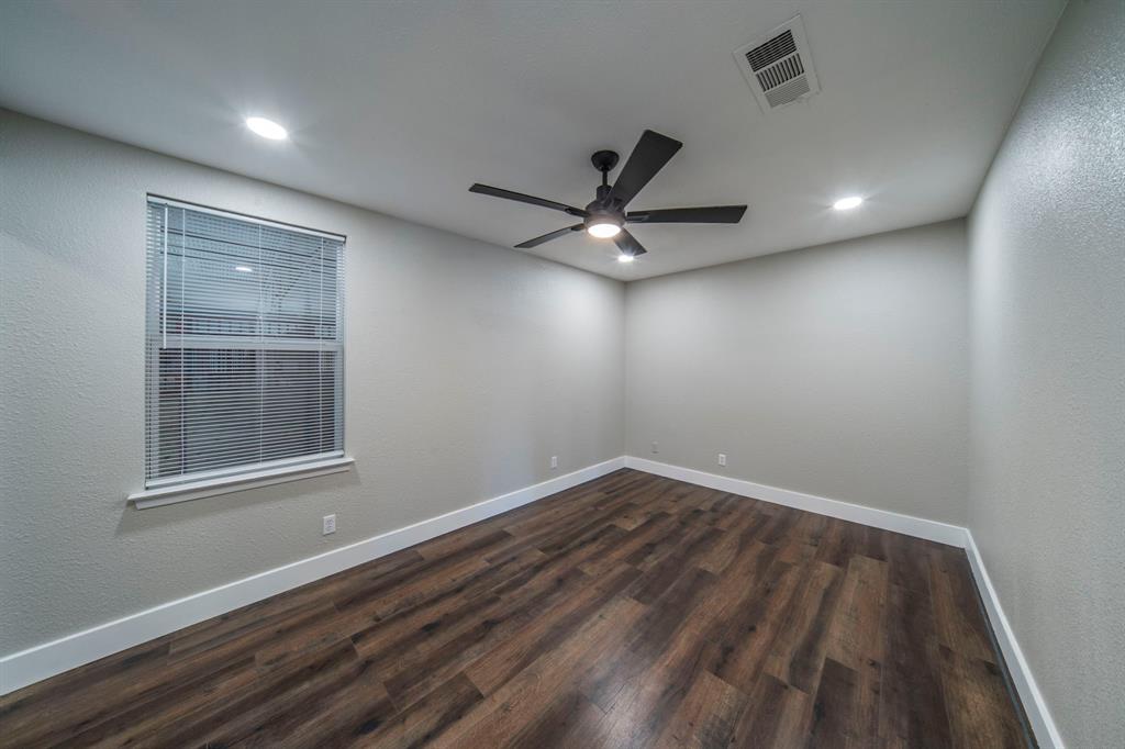 127 County Road 3051 Decatur, TX 76234 - Photo 23 of 35 an empty room with wooden floor and windows