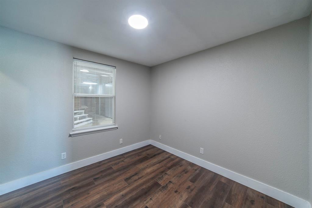 127 County Road 3051 Decatur, TX 76234 - Photo 25 of 35 an empty room with wooden floor and windows
