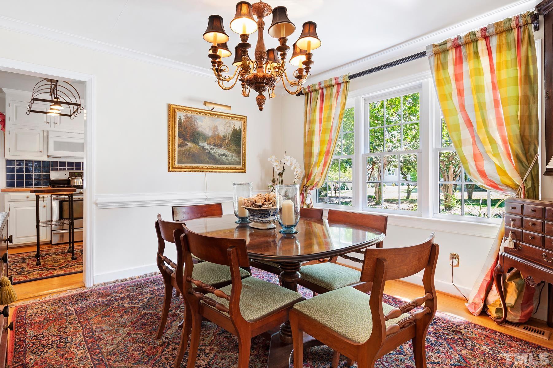 802 Lake Boone Trail Raleigh, NC 27607 - Photo 7 of 30 a dining room with furniture a large window and a chandelier