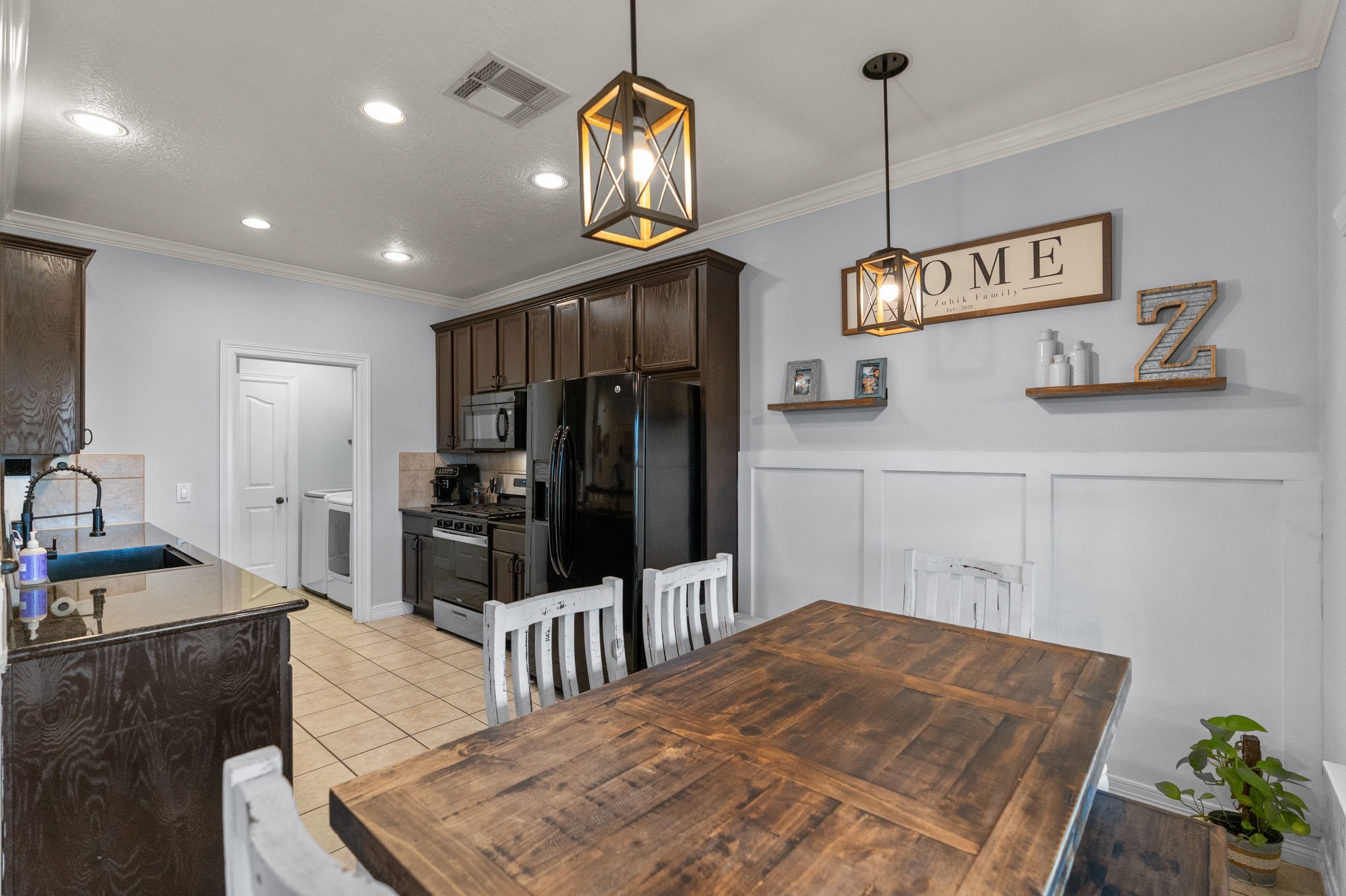 5942 Wildflower Road Sealy, TX 77474 - Photo 11 of 41 a kitchen with stainless steel appliances granite countertop a sink a stove and a refrigerator