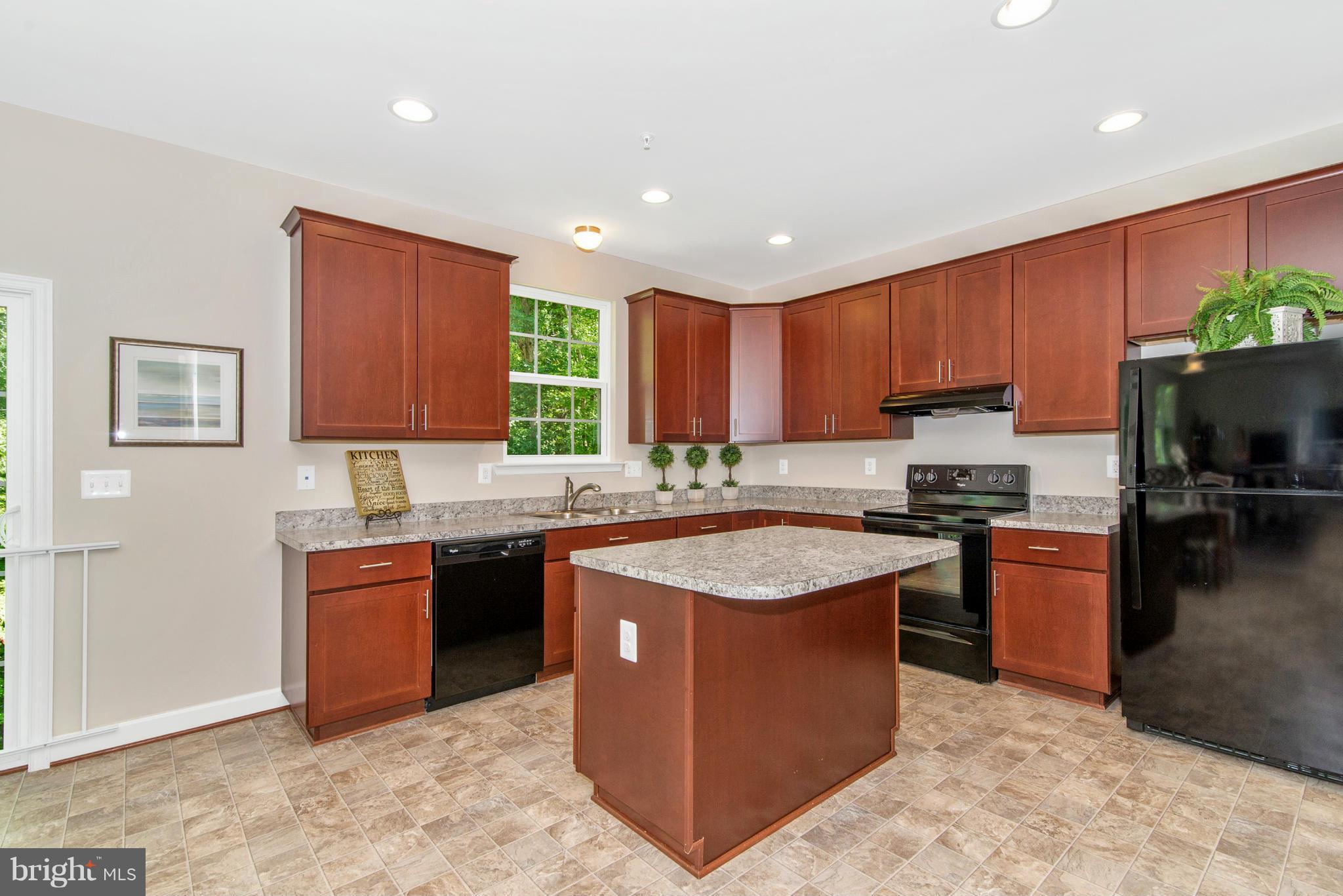 11 Cassidy Court Point of Rocks, MD 21777 - Photo 5 of 30 a kitchen with stainless steel appliances granite countertop wooden cabinets a stove top oven a sink and dishwasher