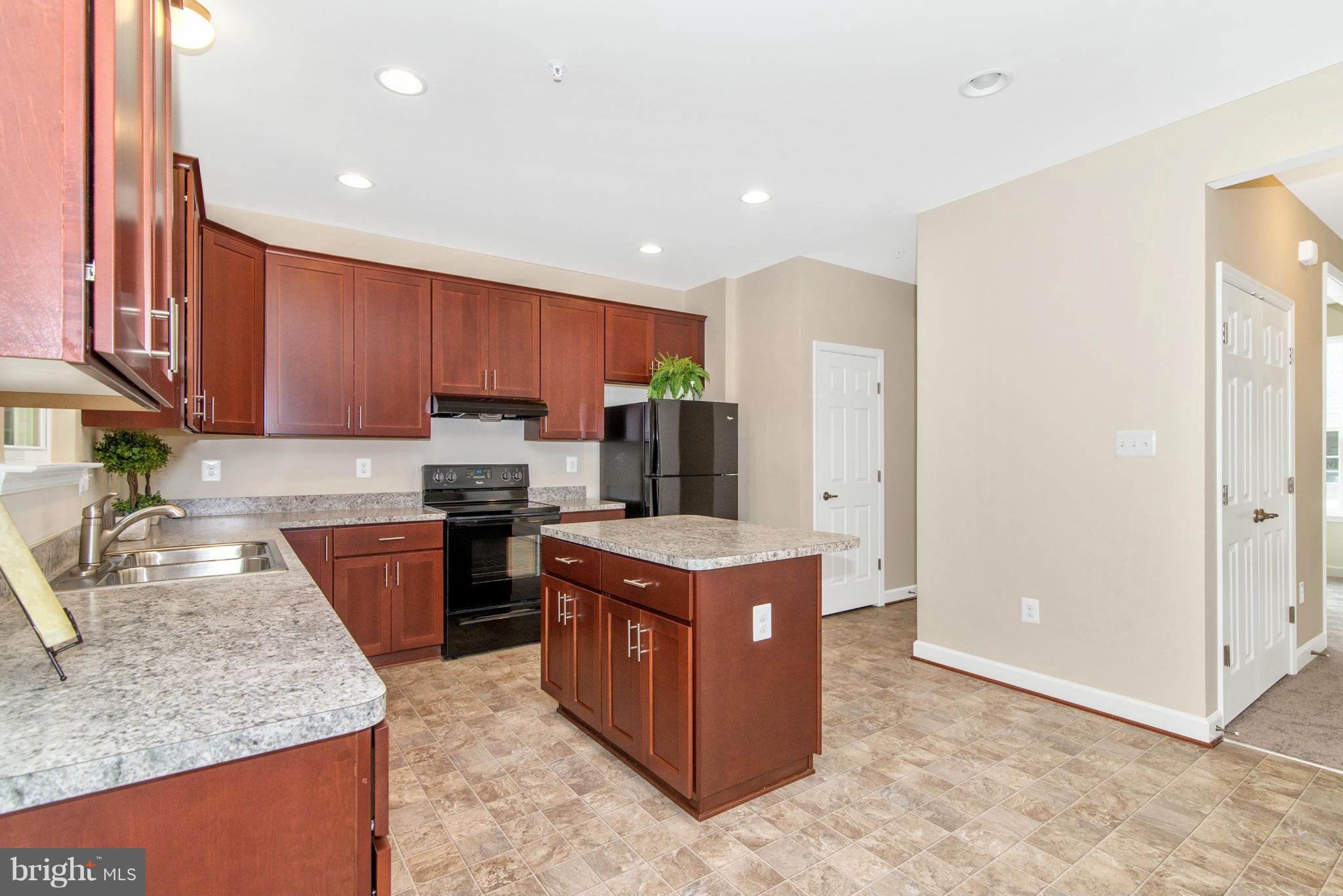 11 Cassidy Court Point of Rocks, MD 21777 - Photo 6 of 30 a kitchen with stainless steel appliances granite countertop wooden cabinets and a stove top oven