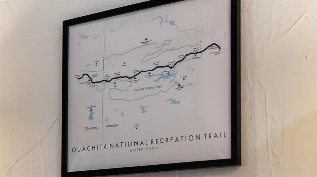 a bedroom with a large bed and a flat tv screen on dresser