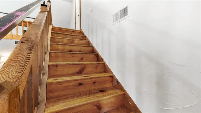 a bedroom with a bed and a lamp on dresser